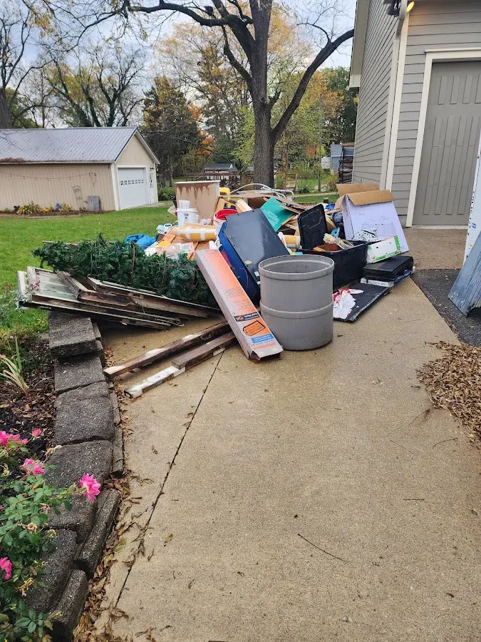 Dumpster being loaded with debris for 3 Yard Dumpster Rental in Port Washington